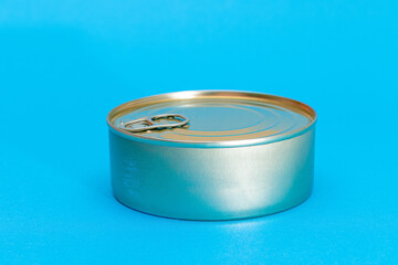 Unopened Tin Can with Blank Edge on Light Blue Background. Canned Food. Aluminum Can for Safe and Long Term Storage of Food. Steel Sealed Food Storage Container