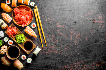 Set of traditional Japanese sushi and rolls with marinated ginger and soy sauce.