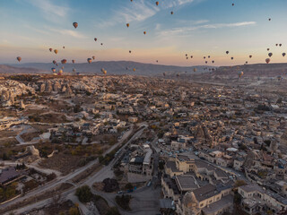 hot air balloons at fairy chimneys at sunrise in G reme, Cappadocia.