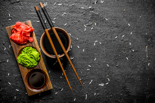 Soy sauce in a bowl with chopsticks for sushi.