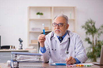 Old male doctor pharmacist in drugs synthesis concept