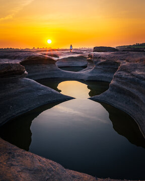 A woman standing in the canyon with water refection in Thailand