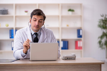 Young male doctor in telemedicine concept