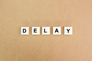 letters of the alphabet with the word delay. the concept of late delivery or attendance. the concept of delay