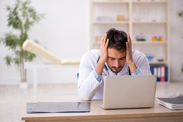 Young male doctor working in the clinic