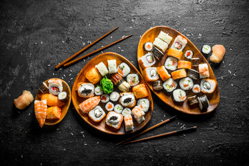 Different kinds of Japanese sushi rolls with salmon, shrimp and vegetables.