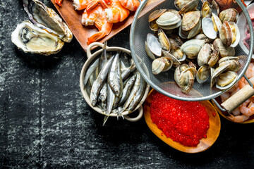 A variety of delicious seafood with caviar on the plate.