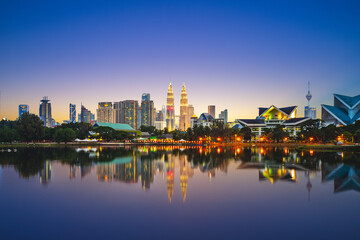 Skyline of Kuala Lumpur by the lake at dusk