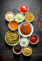 Barbecue sauce, pesto, mayonnaise, mustard with thyme sprigs.
