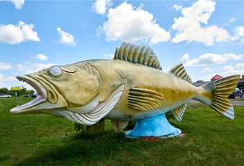 Large old walleye fish sculpture next to the hiway near Rush City Minnesota USA
