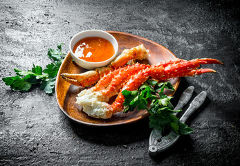Fresh crab on a plate with parsley and sauce. © Artem Shadrin