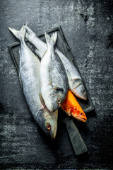 Raw sea fish on wooden cutting Board.