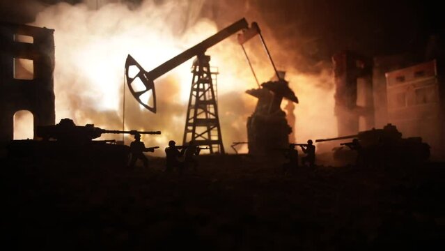 Artwork decoration. Oil war concept. Military silhouettes at oilfield with pumps and rigs. Misty colorful sky background. Armored vehicles fighting scene. Selective focus