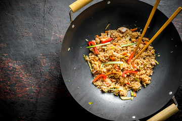 Chinese wok. Rice with vegetables and beef.