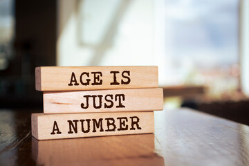 Wooden blocks with words 'Age is just a number'.