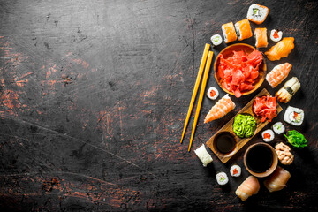 Set of traditional Japanese sushi and rolls with marinated ginger and soy sauce.