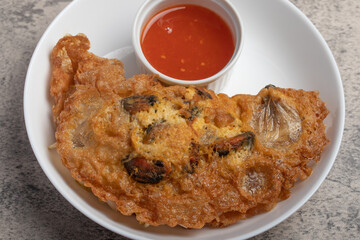Fried mussels in crispy batter in a white plate