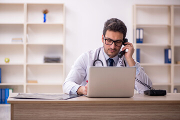 Young male doctor in telemedicine concept