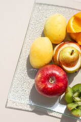 Fresh fruits in plate on white table. Acceptable fruits for diabetes. Kiwis,grapes,orange, apples,pears,Healthy diet and low-calorie diet.Healthy vegetarian food. copy space