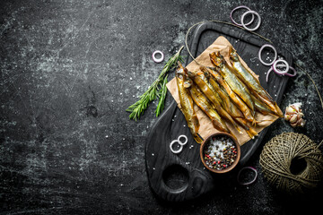 Smoked fish with old twine, spices and onion rings.