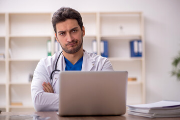 Young male doctor in telemedicine concept