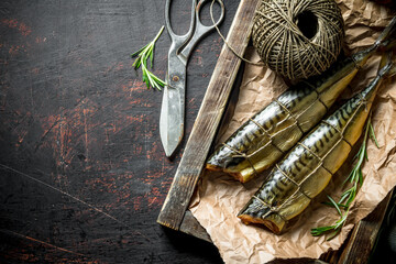 Smoked mackerel on a wooden tray with old twine.