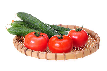 Tomatoes and cucumbers on white background