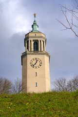 Tower of Great Church Fluntern in bright sunlight at City of Zürich on a blue cloudy autumn day. Photo taken December 8th, 2022, Zurich, Switzerland.