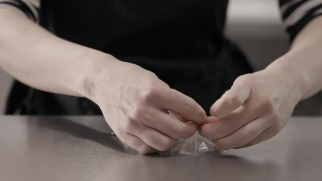 Tiny package with handmade butter cookie neatly tied with a jute twine bow, 4K