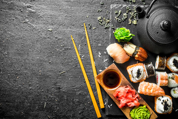 Sushi rolls with shrimp and salmon on a stone Board.
