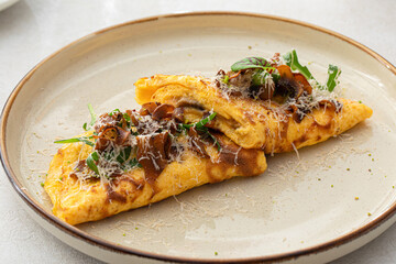 Portion of gourmet omelette with mushrooms and cheese