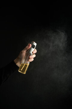 hand with oil sprey