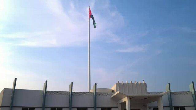 Emirates National Flag Waving on Pole Above Union House, Etihad Museum Complex, Dubai UAE