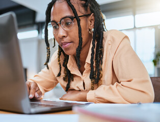 Black woman, laptop and focus reading communication for email conversation, web management or planning strategy. African girl, typing and online networking or check digital marketing on tech device