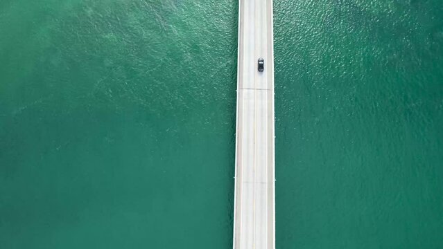 Cars driving over bridge, surrounded by ocean - overseas highway florida keys