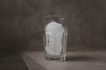 Empty glass with ice cubes, front view with details