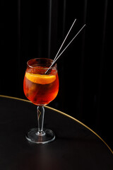 Glass of red alcohol cocktail on the table in a bar