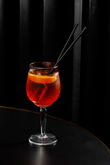 Glass of red alcohol cocktail on the table in a bar