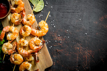 Fried shrimps on a cutting Board with sauce.