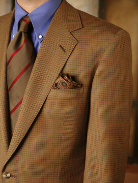 Close-up of brown sports coat worn on a man.