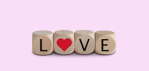 Love cubes isolated on pink background. Valentine's day concept.