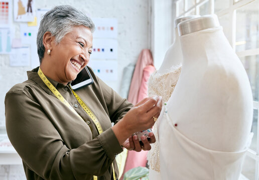Fashion, designer and phone call of woman with mannequin in workshop. Startup, smartphone and happy elderly female seamstress or tailor talking or networking with contact while sewing dress on dummy