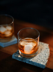 The glass of an iced bourbon whiskey