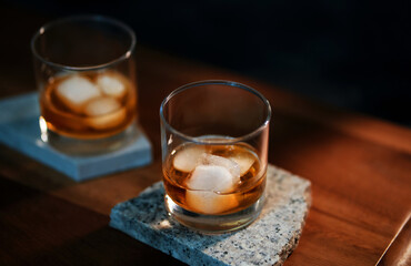 The glass of an iced bourbon whiskey