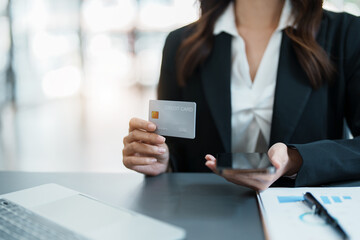 Online Shopping and Internet Payments, Asian woman are using their credit card and mobile phone to shop online or conduct errands in the digital world.