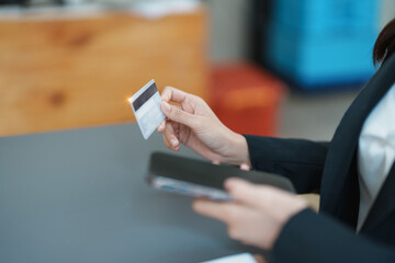 Online Shopping and Internet Payments, Asian woman are using their credit card and mobile phone to shop online or conduct errands in the digital world.