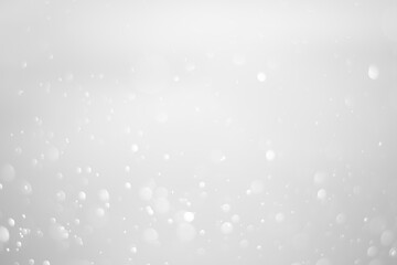 White glitter vintage lights background.  White bokeh shiny on dark background.