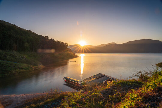 The sunrise over reservoir with mountain background in the northern of Thailand