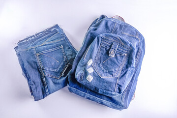 Old jeans ready to upcycling and a bag, made from old jeans pieces. Concept of things reuse and natural resources preserving. 