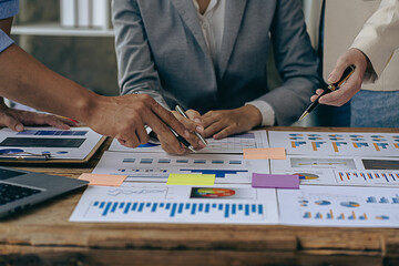 Intelligence analysis concept, group of business people brainstorm discussing current finance and economy on company investment laptop at meeting